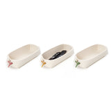 Photo showing three wool white remote holders from Skandinavious with pink yellow and green leather toggles