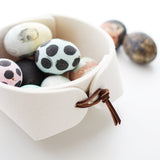 Skandinavious white felt catch all with brown leather toggles shown with easter eggs